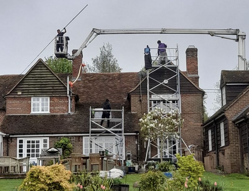The Moss Cleaners using cherry picker and scaffolding to clean roof safely and professionally in Fordingbridge, Hampshire